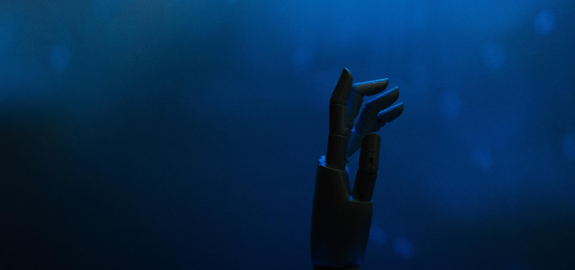 Robotic hand emerging through blue light